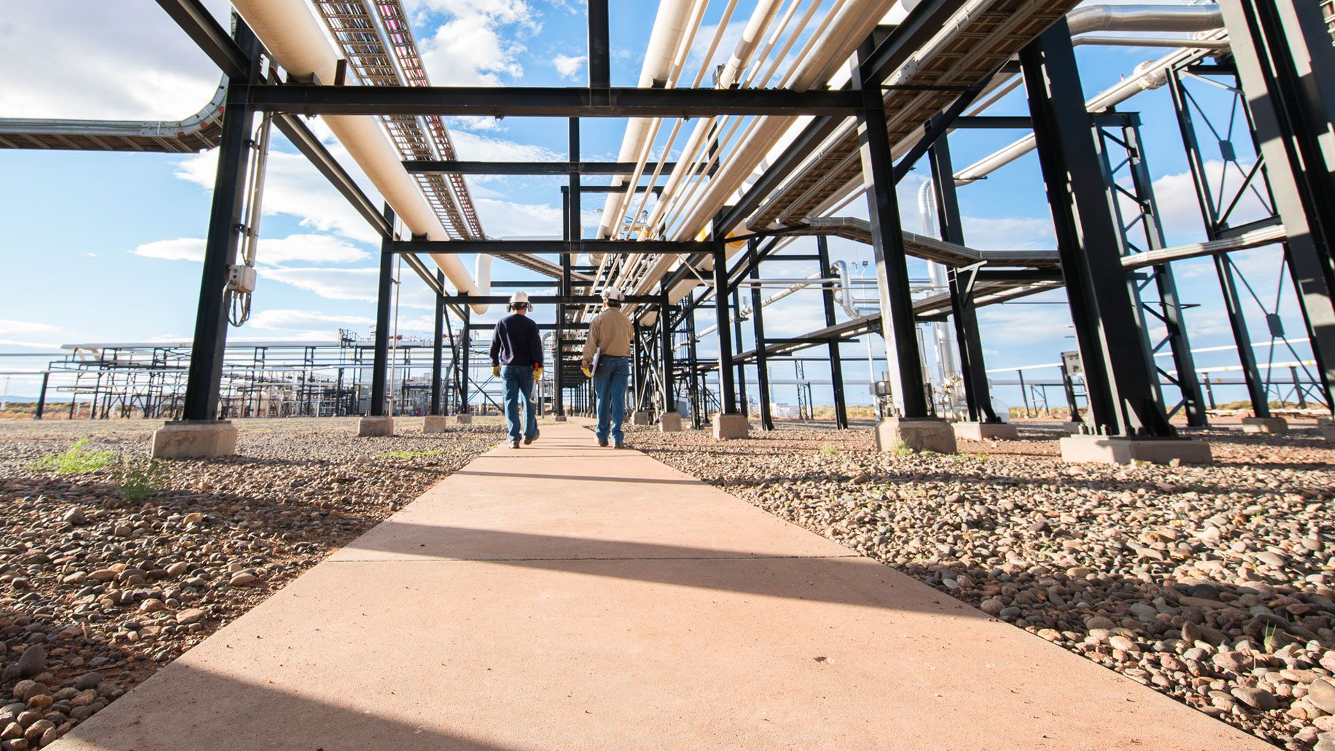 WD Employees under a pipe construction