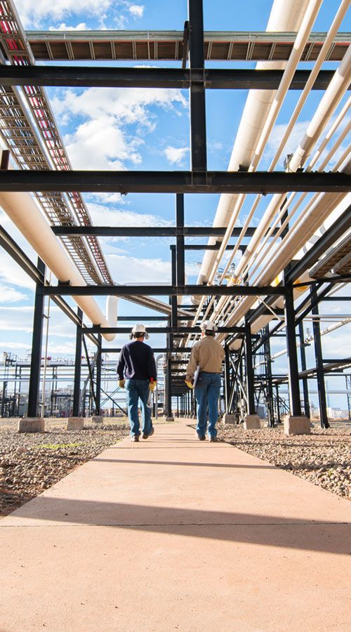 WD Employees under a pipe construction